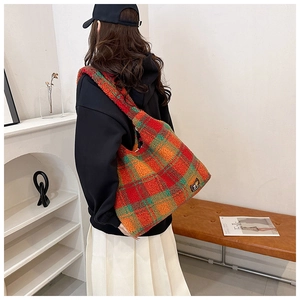 Detailed look at the large plaid plush tote bag with fuzzy texture and shoulder strap