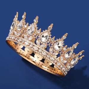 Close-up of golden bridal crown featuring teardrop crystals and heart patterns
