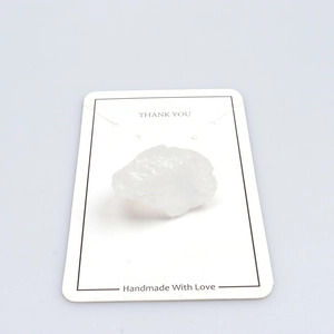 Macro view of a natural translucent white crystal stone on a handmade display card