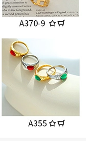 Detailed view of vintage gold and silver rings with red and green gemstones on display