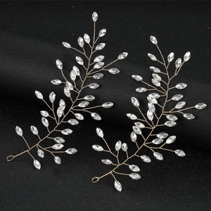 Handcrafted crystal branch hair clips set with gold wire and rhinestones on black stand