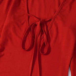 Detail of red sexy dress featuring a lace-up low-cut U-neck with soft elastic fabric