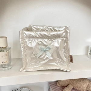 Detail of quilted PU storage box featuring a satin blue bow and elegant lace trim