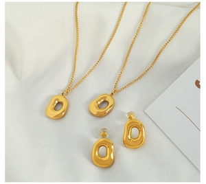 Detailed shot of two sets of irregular hollow oval necklaces and earrings in 18k gold finish