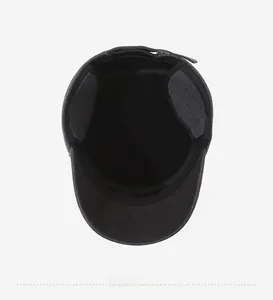 Detail of gray flat cap showing black fleece lining and foldable earmuffs for winter warmth