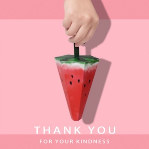 Creative watermelon shaped candy gift box with green handle and vibrant red interior design