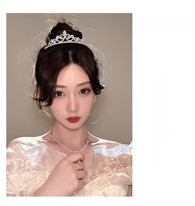 Exquisitely crafted silver crown with brilliant rhinestones and intricate heart patterns