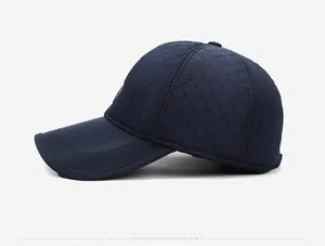 Side view of navy blue baseball cap with diamond quilted stitching and curved brim