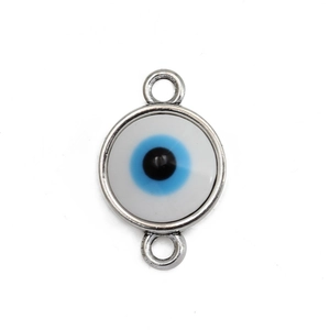 Macro shot of silver-framed evil eye triangle charms for DIY jewelry making