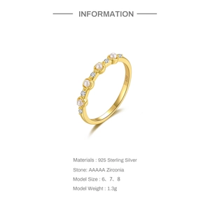 Detail view of S925 sterling silver ring with pearls and round zirconia in gold finish