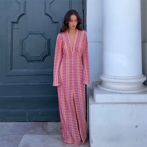 Detail of bohemian V-neck maxi dress with colorful floral print and long sleeves