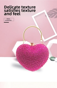 Detail of pink heart rhinestone evening bag with elegant golden circular metal handle