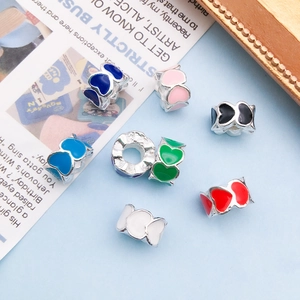 Macro shot of colorful enamel heart charms for DIY jewelry making and bracelets