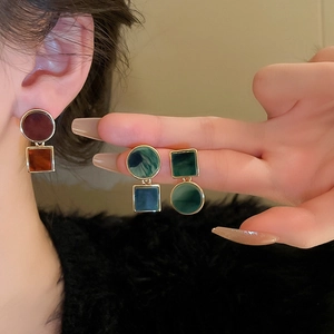 Detailed view of geometric retro resin earrings with vintage marble texture and gold edges