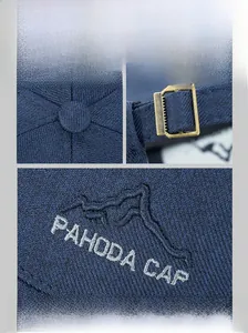 Detailed embroidery of mountain peaks and metal buckle on dark blue baseball cap