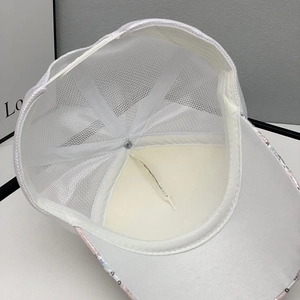 Detail view of breathable white mesh baseball cap with interior stitching and sequins