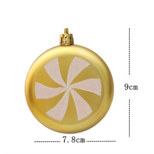Detailed view of a 9cm golden Christmas ball with white glitter spiral patterns
