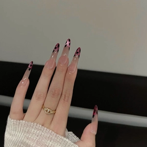 Pink leopard print cat-eye press-on nails with glitter on long almond-shaped tips