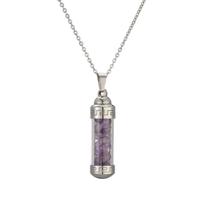 Detail of silver cylindrical perfume bottle pendant filled with purple gravel stones