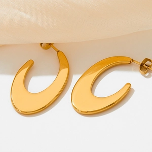 French style gold-plated C-shape oval hoop earrings on elegant beige silk background