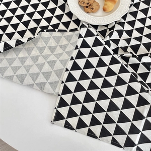 Macro detail of black and white geometric cotton linen tablecloth with triangle pattern