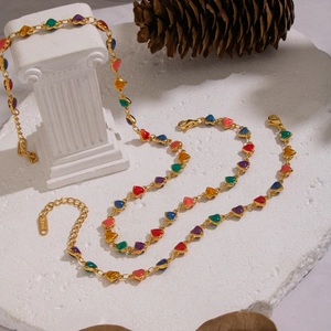 Detailed macro view of colorful heart-shaped beads on a gold stainless steel necklace