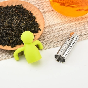 Creative green silicone man tea infuser with stainless steel strainer over a tea cup