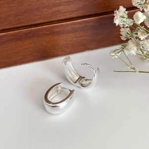 Minimalist 925 sterling silver hoop earrings shown in a premium lifestyle setting
