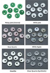 Macro display of assorted 18mm crystal donut beads including rose quartz and white jade