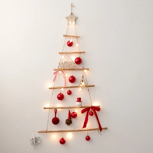Hanging wooden Christmas tree with LED lights and red star ornaments for wall decor