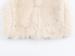 Detail of cream faux fur vest showing soft high-density plush texture and fine hem craftsmanship