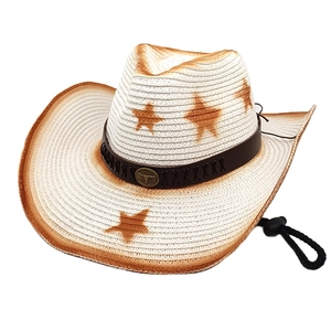 Detail of woven cowboy hat with star pattern, bull head emblem and adjustable chin strap