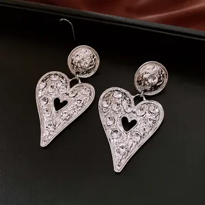 Vintage oversized silver heart earrings with hammered texture and sparkling crystals