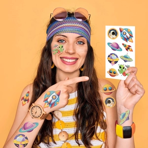Close-up of space theme temporary tattoos featuring rockets and planets on skin