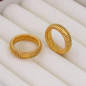 Vintage style gold-plated Tubogas rings with horizontal texture in a jewelry box