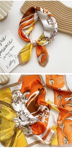 Detail of silk square scarf showing equestrian patterns with bits and chains texture