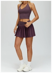 Detail of mulberry purple pleated sports skirt with high-density stretch performance fabric