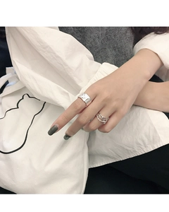 Close-up of model wearing S925 silver rings with irregular textures and interwoven bands