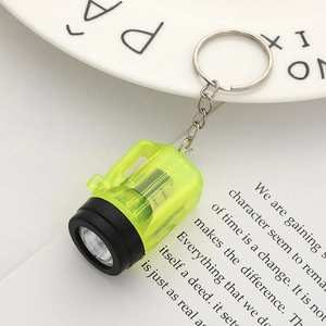 Macro detail of portable mini LED flashlight keychain in neon green translucent finish