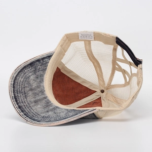 Detail view of washed denim baseball cap with criss-cross ponytail hole and mesh back