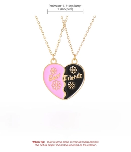 Detail of Best Friends split heart necklace in gold finish with pink and black enamel