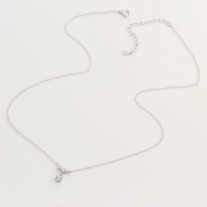 Detail of S925 sterling silver necklace with sparkling snowflake zircon pendants on beige background