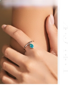 Detailed shot of an S925 sterling silver ring with a blue marquise-cut gemstone pendant