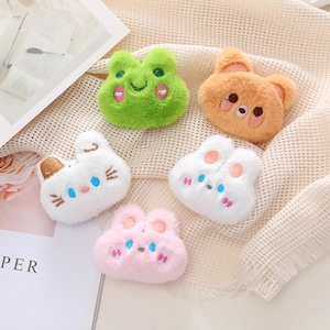 Close-up of cute plush animal brooches featuring detailed embroidery and soft fur texture