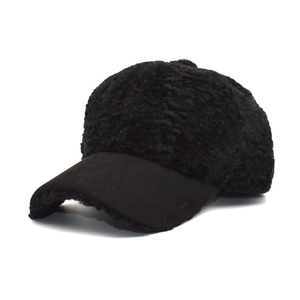 Close-up of black fuzzy faux shearling baseball cap with textured fleece and suede brim