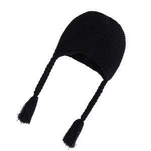 Detail of black knit baby beanie showing earflaps, thick braided tassels and warm texture