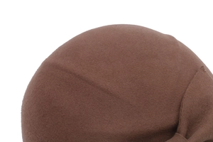 Close-up of brown wool felt beret showing fine texture and elegant curved top design