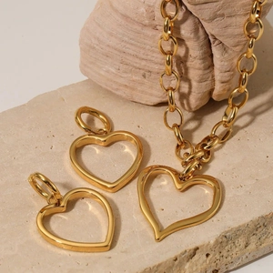 Minimalist golden 316 stainless steel heart necklace and earrings set on natural stone