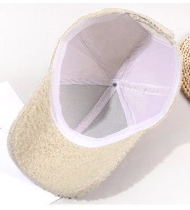 Detail view of the plush teddy fleece texture and internal structure of the baseball cap