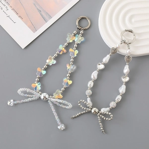 Acrylic pearl bow beaded phone wrist strap with heart charm and silver metal accents